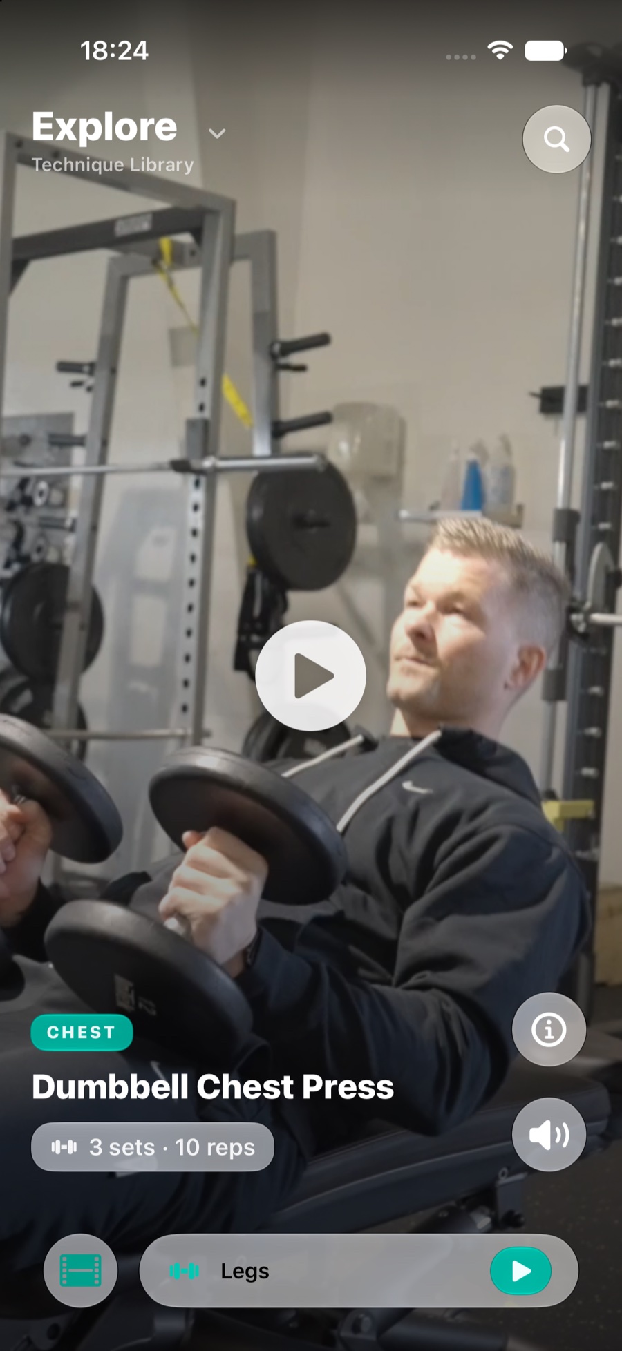The Explore tab playing a technique video for the seated leg extension, with the muscle group and set scheme overlaid.